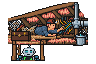 The man crawls through a cramped loft between the rafters with a head torch, reaching for a tangle of cables, while the robot peers up through the loft hatch, too big to fit.